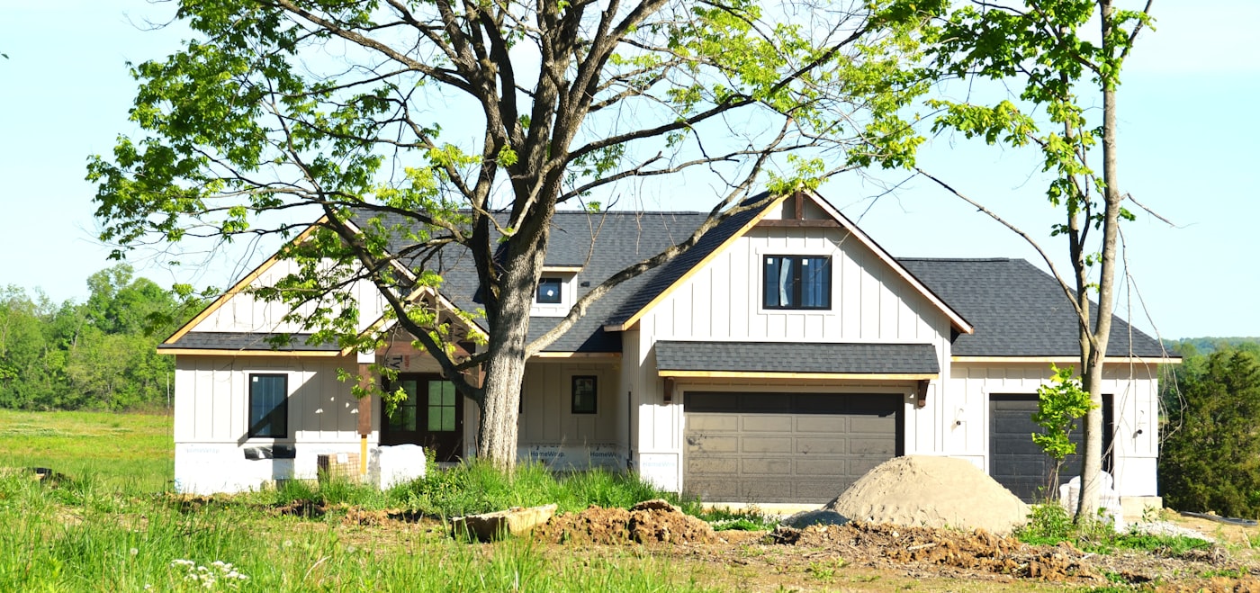 Modern house under construction on a sunny lot
