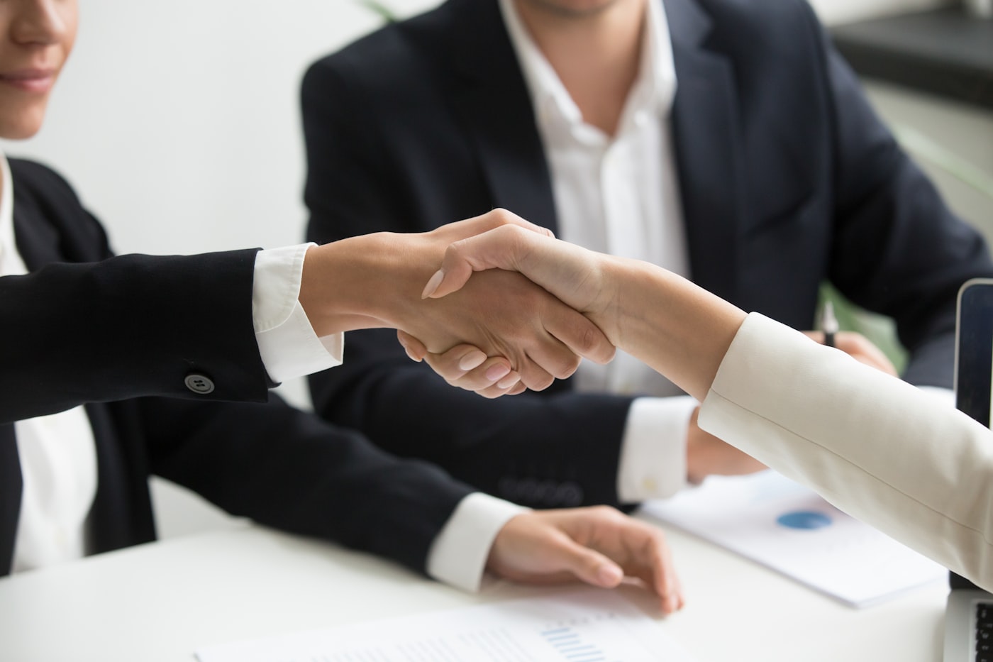 Two people shaking hands after finalizing a financing agreement